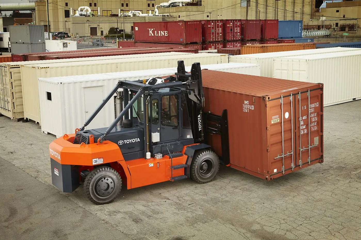 Port terminal with container handlers and yellow forklift